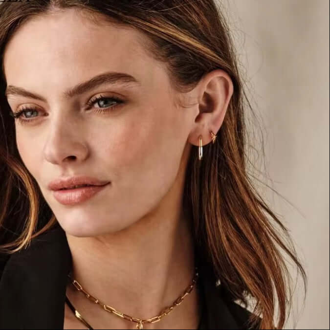 Stylish model showcasing Two Tone Earrings, crafted from Sterling Silver and 14k real Gold-Plated, Rhodium finish.
