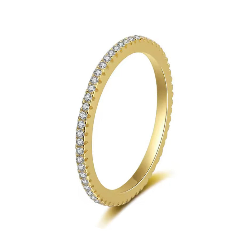 Gold ring with embedded diamonds on a white background
