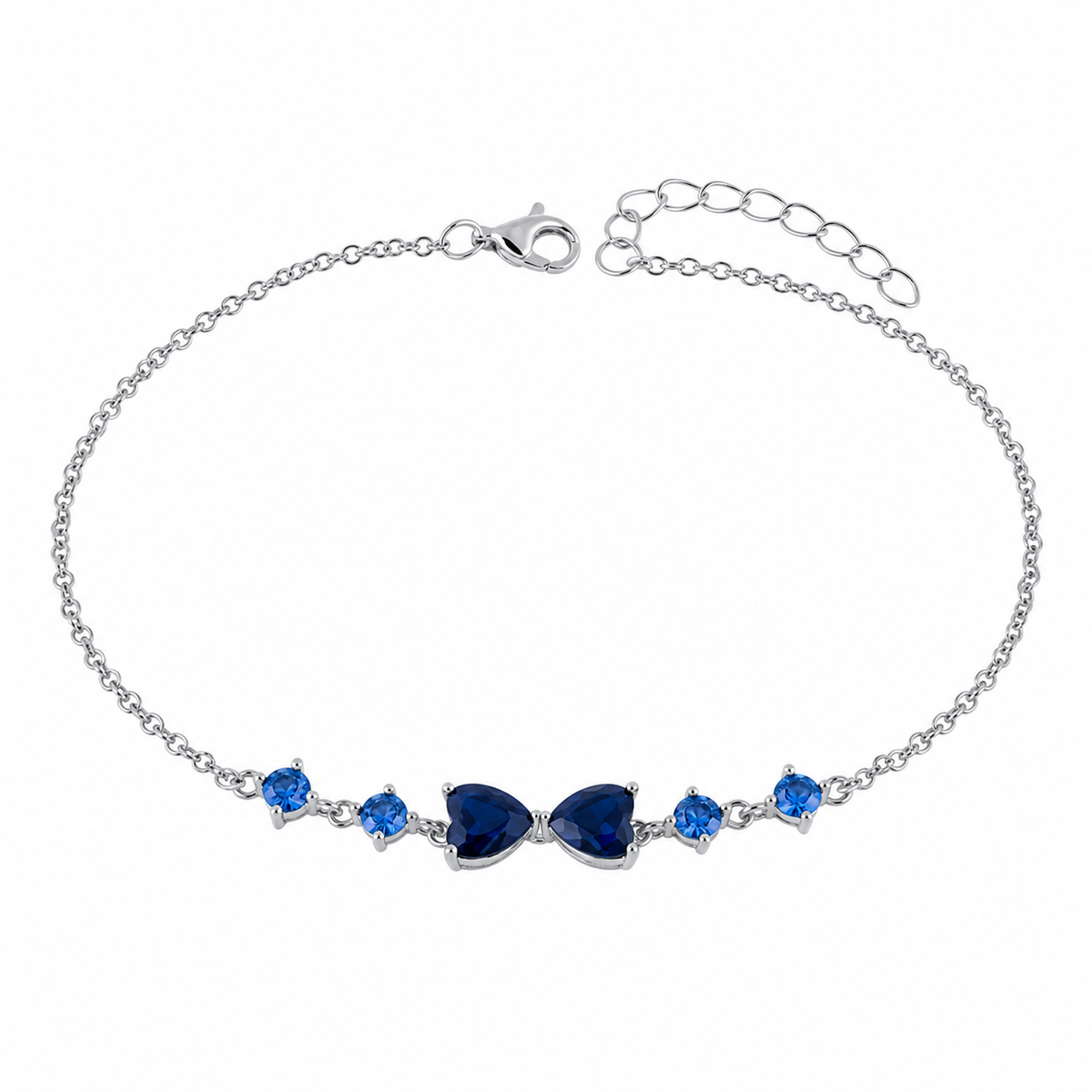 A silver chain bracelet featuring a central bow-shaped cluster of deep blue teardrop gemstones, flanked by two smaller round blue gemstones on each side, shown on a plain white background.