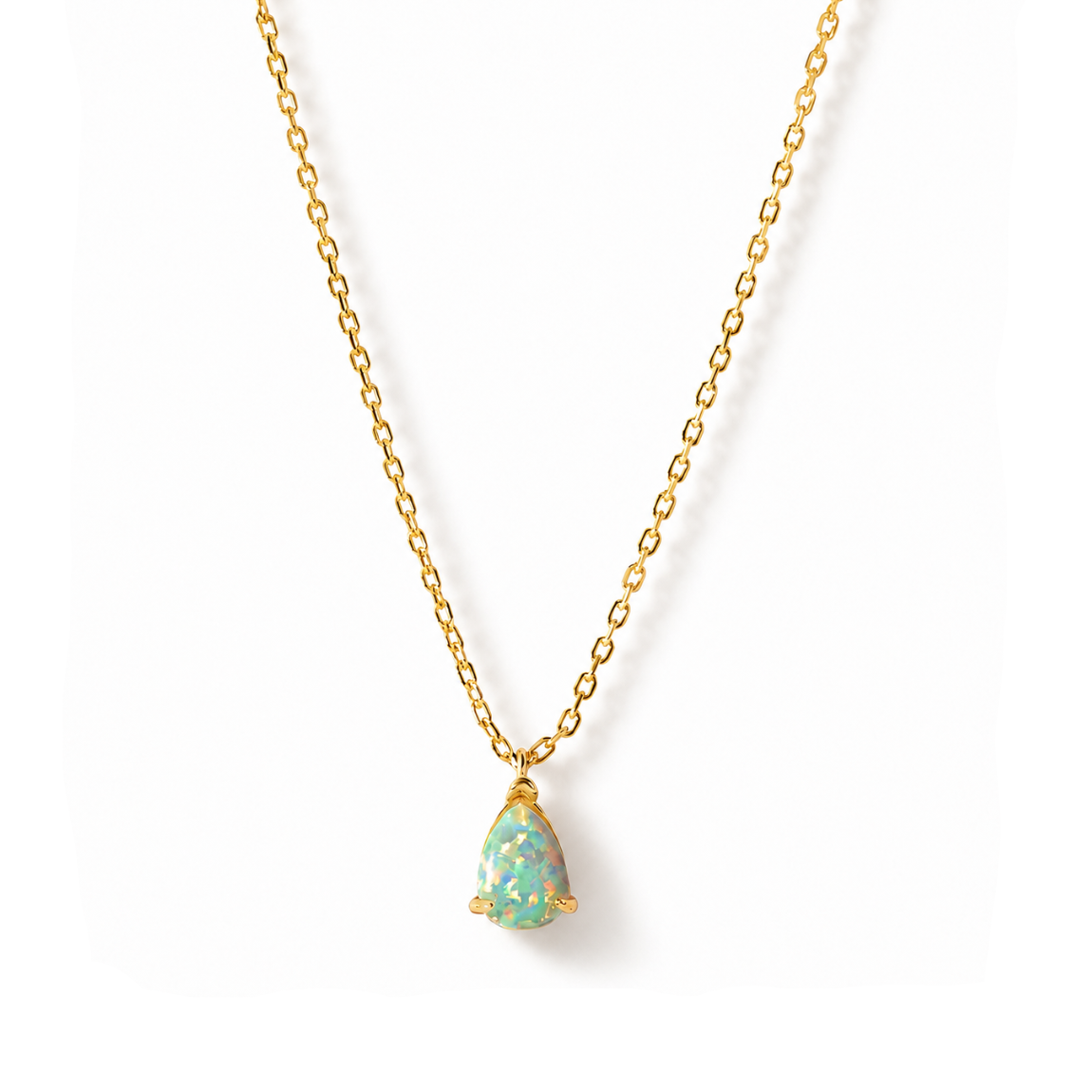 A gold vermeil chain necklace with a teardrop-shaped pendant featuring a light blue-green opal inlay with gold flecks, set against a plain white background.