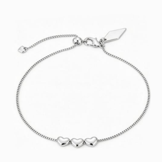 A silver chain bracelet with three small polished heart charms at the front and an adjustable clasp with a flat diamond-shaped tag, shown on a plain white background.