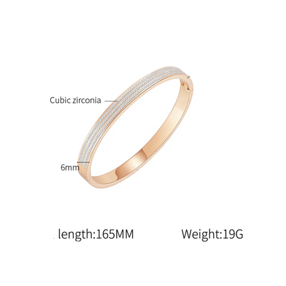 A bangle bracelet with a textured white cubic zirconia inlay, shown on a white background with text labels indicating its materials and dimensions.