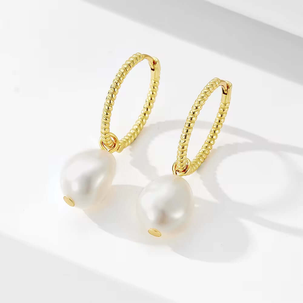 Elegant Pearl Huggies in 925 Sterling Silver, 14k Gold-Plated, featuring a Rhodium finish for added shine.
