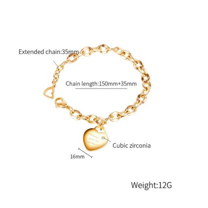 Gold-tone chain bracelet with a heart-shaped cubic zirconia pendant, shown on a white background with text labels indicating rose gold plating, stainless steel construction, extended chain length, chain length, pendant size, and weight 12G.