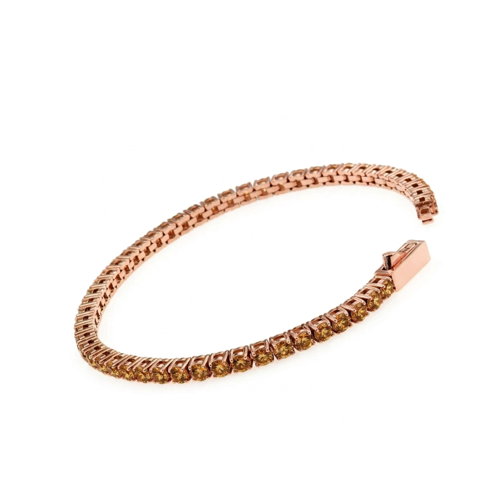 A rose gold tennis bracelet with coffe- coloed stone (a warm, ligth brown to golden brown hue reminiscent of sparkling wine set along the front, displayed on a clean white background.