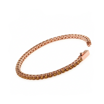 A rose gold tennis bracelet with coffe- coloed stone (a warm, ligth brown to golden brown hue reminiscent of sparkling wine set along the front, displayed on a clean white background.