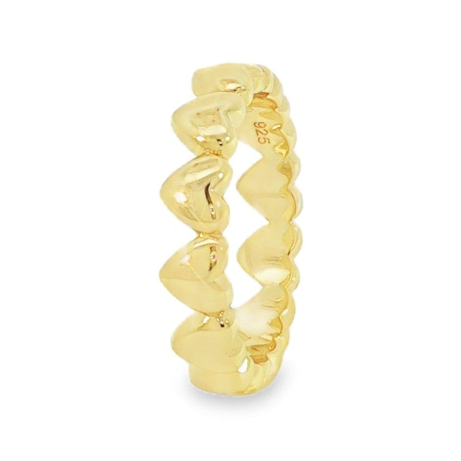 Gold ring with wavy design on a white background